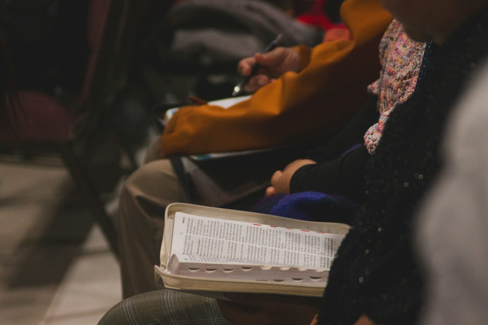 Student reading a Bible during a gathering