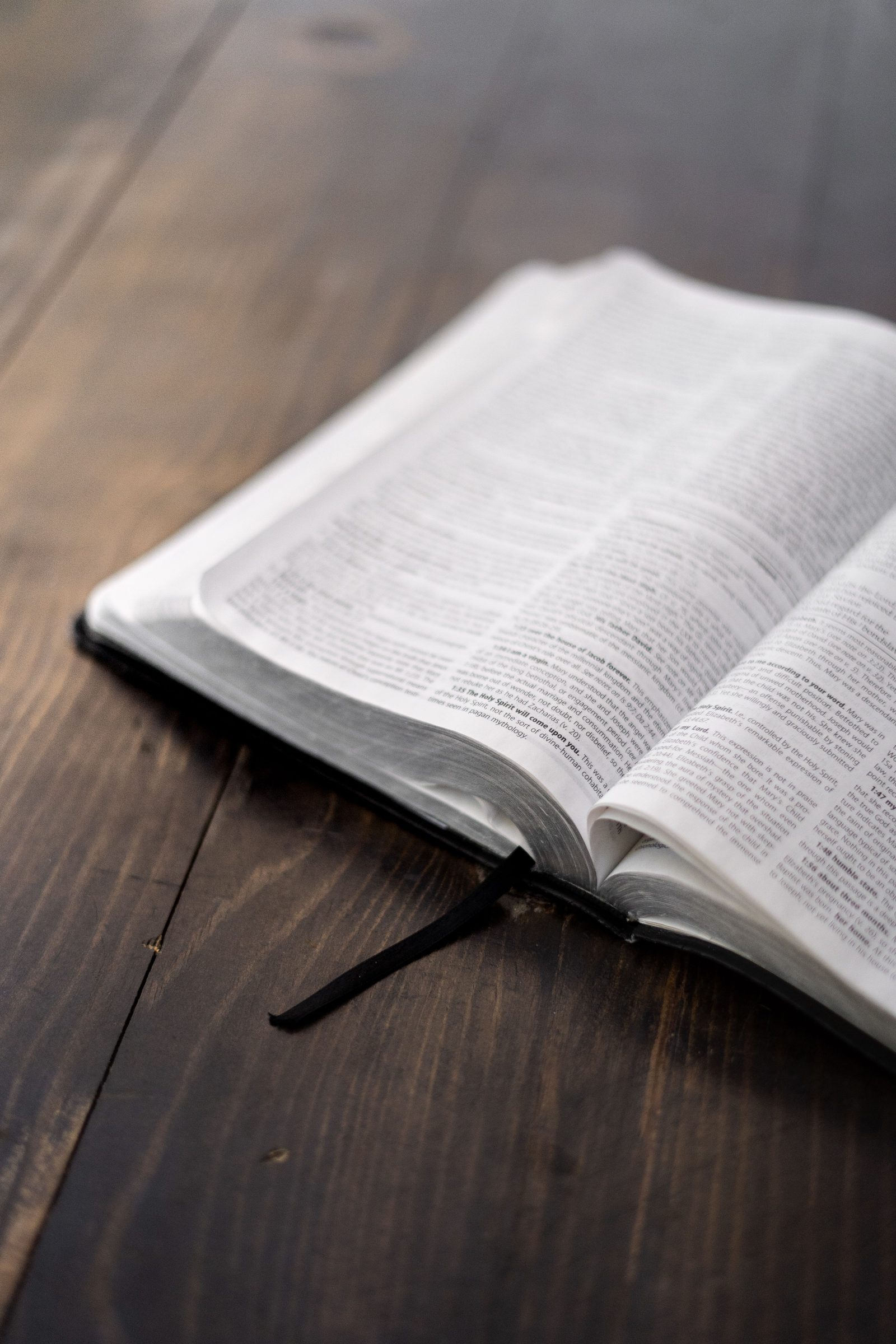 Open Bible resting on a wooden table
